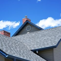 House Roof - Roofing Works. Cloudy Blue Sky. American Building Style.