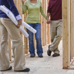 Asian couple and architect in new construction
